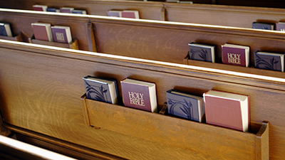 Church pew showing bible and hymnals.- See lightbox for more